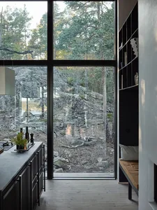 Modern residential kitchen featuring glass and metal elements for an airy, open atmosphere.