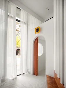 A modern retail space with a clean minimalist aesthetic, featuring glass and wooden elements.