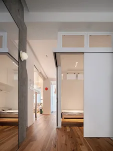 A minimalist residential interior featuring concrete and wooden elements.