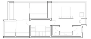 Floor plan of a minimalist residential layout depicting a living area with a couch and table, a bedroom with a bed, and a bat