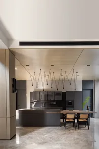 A modern kitchen featuring metallic cabinets and a concrete countertop.