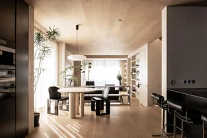 Modern living room with wooden flooring, furniture, and plants.