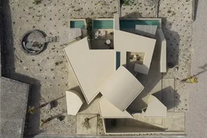 A modern house with a minimalist design, featuring concrete material and a floor plan layout.