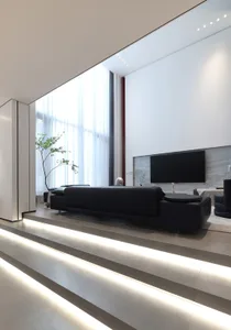 A modern living room featuring large glass windows, a sleek black sofa, and minimalist decor.