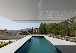 Modern luxury villa featuring a concrete and glass exterior with a swimming pool.