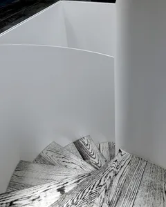 A minimalist staircase with wooden steps viewed from a camera angle.