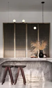 Modern minimalist bar with concrete countertop and metal stools.