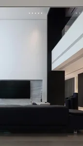 Modern minimalist living room featuring concrete and steel materials.