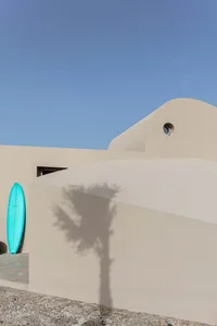 Modern minimalist house with light-colored sandstone exterior.