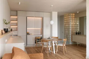 Modern minimalist kitchen with wooden furniture and glass elements.