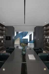 A modern office interior featuring blue metallic accents and black metallic furniture.