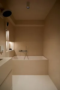 Minimalist bathroom with concrete walls and white floor