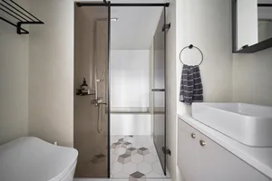Modern bathroom interior with neutral-toned tiles and minimalist design.