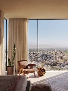 A modern living room featuring a comfortable sofa, modern armchair, and natural stone accents.