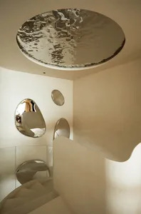 A modern interior with metallic elements and a spiral staircase.