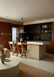 Modern minimalist kitchen with a concrete countertop and wooden seating area.