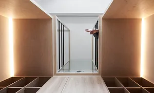 A minimalist residential space featuring light-colored wood and white surfaces.