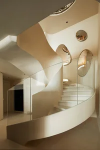 Modern staircase featuring glass railings and concrete steps