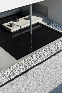 Minimalist modern architectural water feature with stone border.