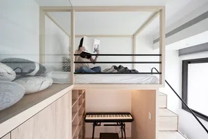 A minimalist study bedroom featuring wooden furniture and a lofted bed.