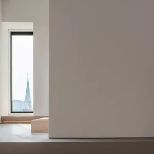 A minimalist window view of a church spire in an indoor setting.