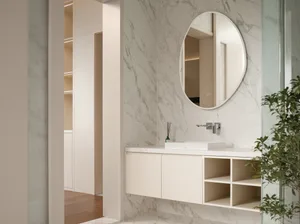 Modern bathroom featuring a marble vanity, sink, and floating shelves with greenery
