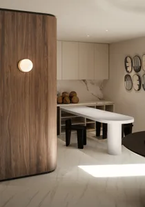 A modern kitchen featuring white marble countertops and walnut wood cabinets.