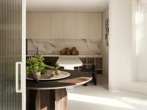 A modern kitchen with marble countertops and wooden cabinets.