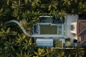 Aerial view of a modern residential architectural plan featuring concrete and glass materials.