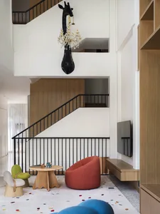 Modern residential living room featuring wooden furniture and colorful accents