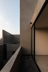 Concrete balcony with black railing and floor tiles