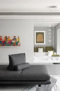 Minimalist living room featuring a fabric couch with a colorful painting on the wall.