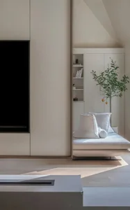 A minimalist living room with a sofa and a bookshelf