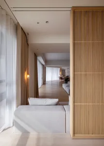 A minimalist residential interior featuring wood and fabric elements.