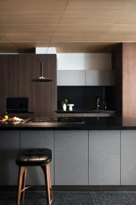 A modern kitchen featuring black marble countertops and minimalist design elements.