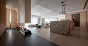 A modern kitchen with a white marble floating island and granite countertop, featuring a minimalist design aesthetic.