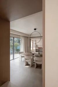 Contemporary living room with minimalist design, featuring wood and glass furniture and fixtures.