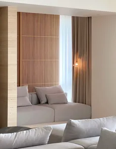 A minimalist living room featuring a wooden feature wall, upholstered seating, and soft lighting.