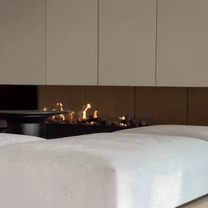 Modern living room featuring a textured sofa and a fireplace emitting warm flames.