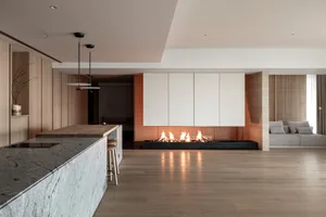 A modern living room featuring wooden flooring and minimalist furniture.