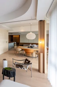 A modern living room featuring wooden flooring and furniture.