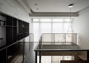 Modern residential interior with a sleek, black metal staircase featuring a white metal handrail and a matching black metal r
