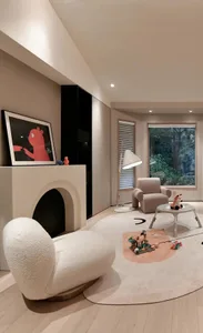 A modern, neutral-toned living room with a comfortable seating area and a fireplace.