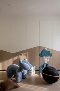A cozy playroom with a ball court, stuffed animal, and storage bin.