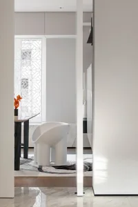 Modern minimalist living room featuring white sculptural chairs.