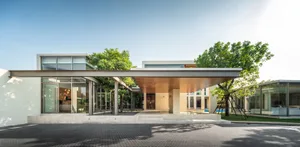 Modern residential exterior with glass, concrete, and wood materials