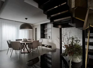 A modern dining room with marble accents, featuring a circular table surrounded by six chairs.