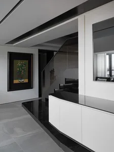 A modern interior design featuring concrete and glass materials.