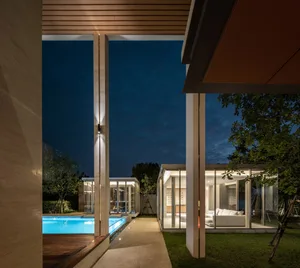 Modern residential exterior showcasing glass walls and a cantilevered design