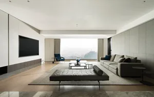 A modern living room with marble flooring and minimalist furniture.